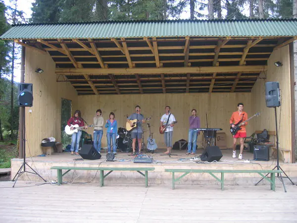 Worship band performing on the covered outdoor stage