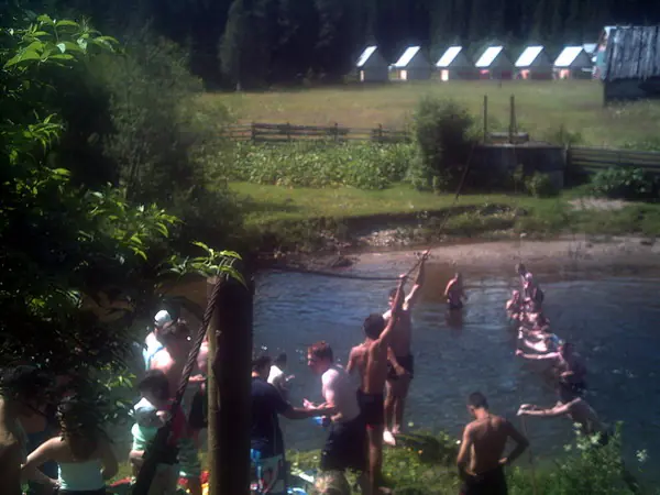 Campers bathing in a mountain stream on a sunny day
