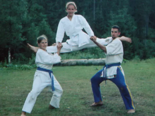Karate demonstration with a high flying kick on the grass