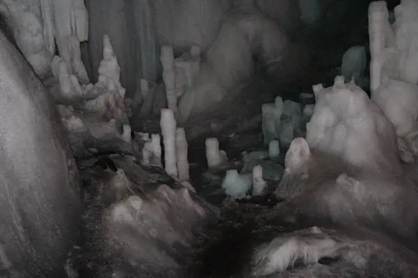Ice formations covering the floor of Scărișoara Ice Cave